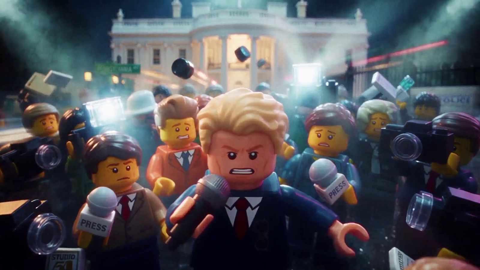 Lego Trump in a press scrum, reporters with microphones and cameras